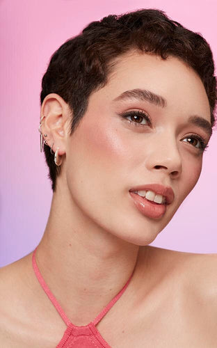 short, brown-haired woman in makeup